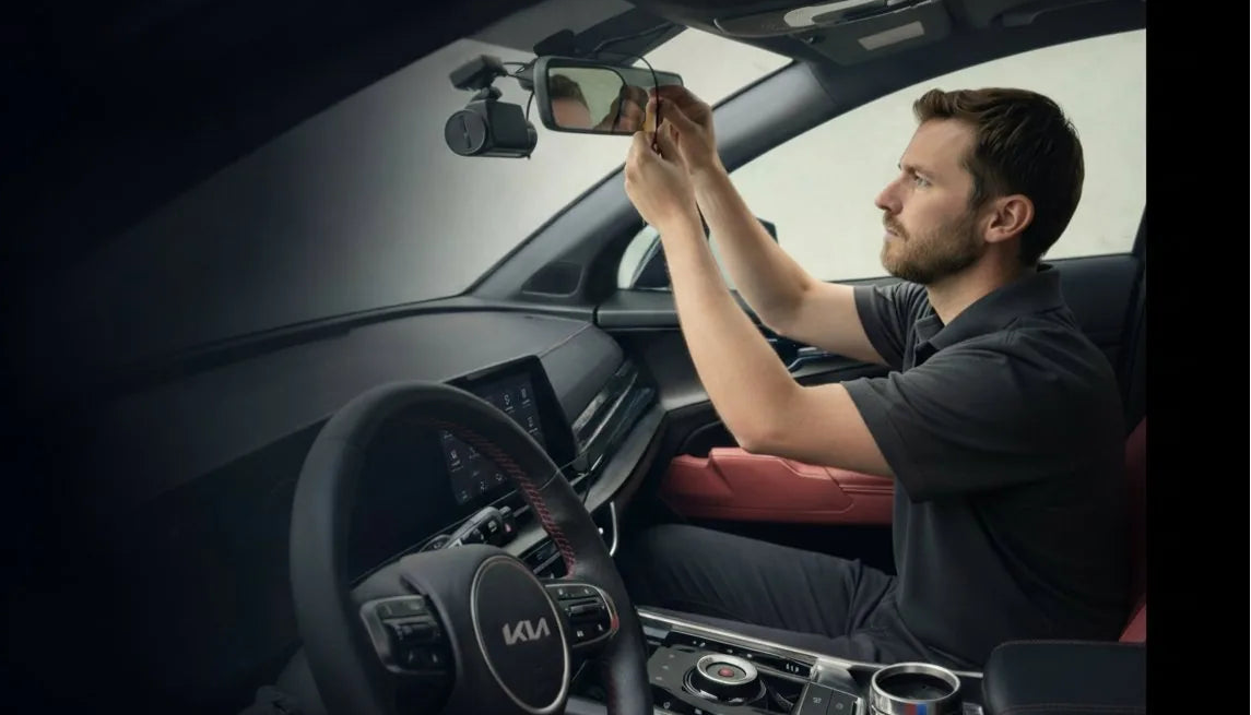 Person installing LYNX Guardian 360 dash cam on windshield