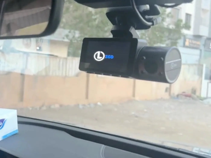 The LYNX Guardian 360 mounted behind the rear-view mirror, its screen lit after the car is started.